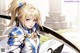 A girl in a white and blue outfit holding a sword.